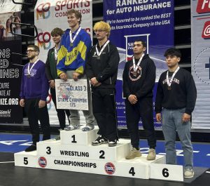 Marshall’s Mason Evans (right) earned his first medal at the Missouri State High School Championships last Saturday at Mizzou Arena in Columbia. The senior, wrestling in the 175-pound weight class, brought home sixth place in the Class 3 Tournament. (Contributed image)
